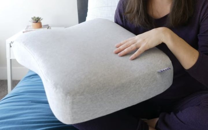Checking how soft the fabric of the pillow for neck arthritis
