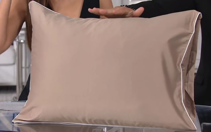 Inspecting the softness of the copper-infused pillow and pillowcase