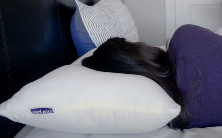Lying down on the side sleeper pillow to ensure it's breathable and supportive